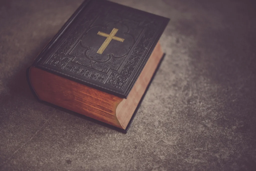 A closed Bible with a gold cross on its cover