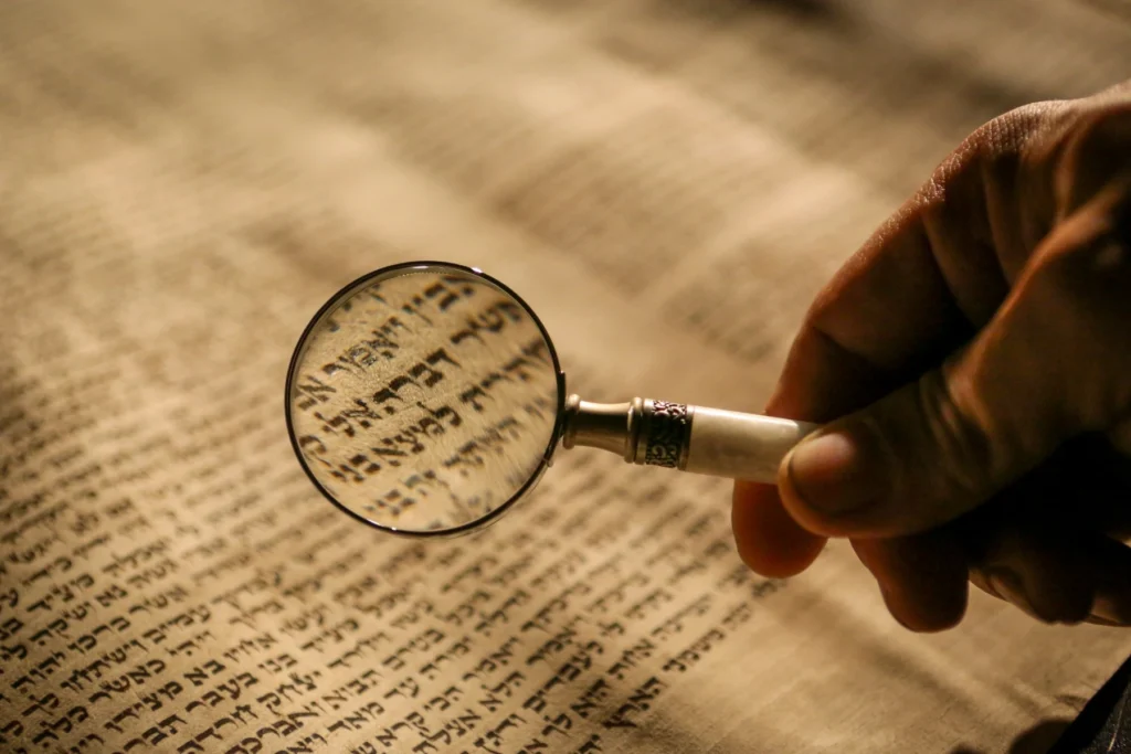 A magnifying glass held over Hebrew text